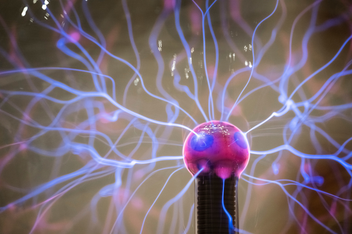 Plasma filaments radiate from an inner electrode to the outer glass insulator of a plasma ball as seen during a demonstration in a geoscience class