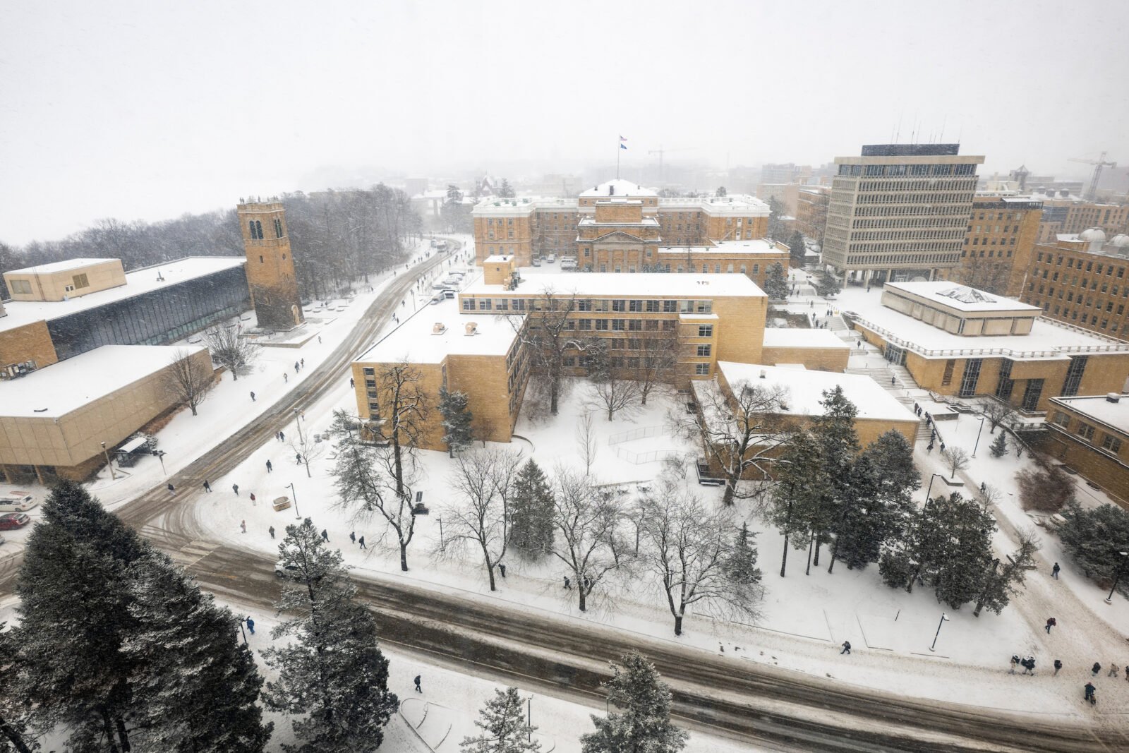 From left to right, Sewell Social Sciences Building, Carillon Tower, Bascom Hall, Ingraham Hall and Van Vleck Hall are pictured as snow falls on central campus as seen from a Van Hise office window at the University of Wisconsin–Madison during winter on Feb. 12, 2025. (Photo by Jeff Miller / UW–Madison)
