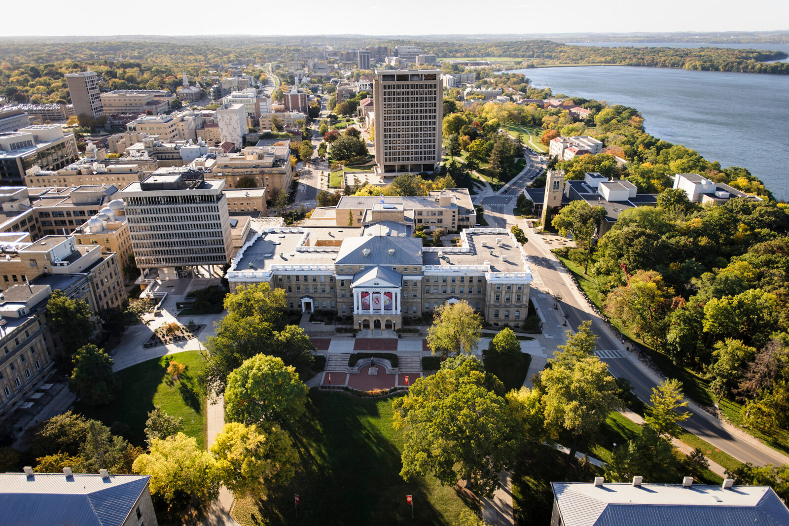 Bascom Hall, Bascom Hill and the central University of Wisconsin-Madison campus are pictured in an aerial view during autumn on Oct. 12, 2013. Clockwise from the left, major campus facilities include South Hall, Birge Hall, Van Vleck Hall, Van Hise Hall, Carillon Tower and North Hall. In the background at right is Lake Mendota. The photograph was made from a helicopter looking west. (Photo by Jeff Miller/UW-Madison)