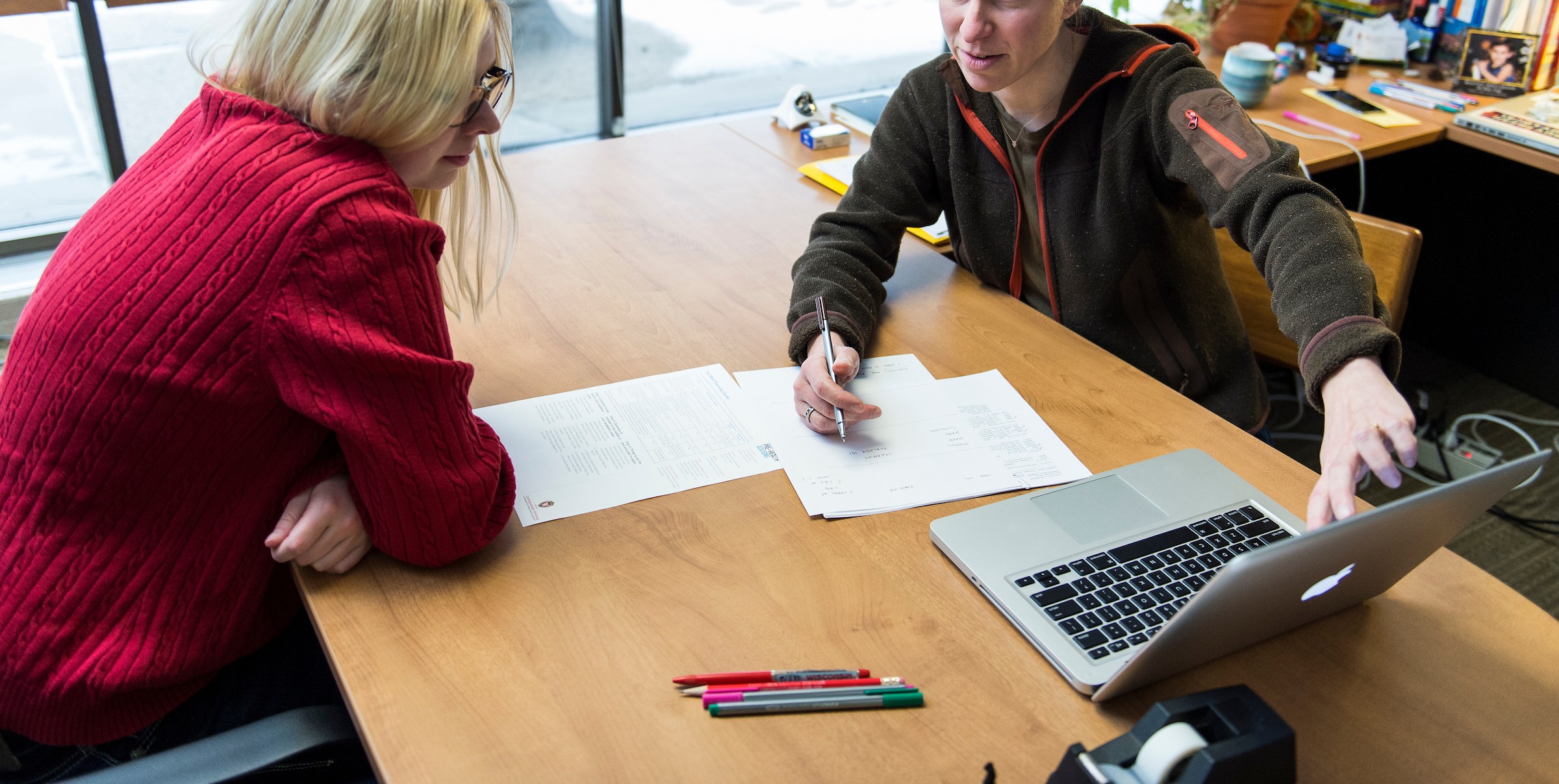 Pre-Health advisor with student in advisor's office.