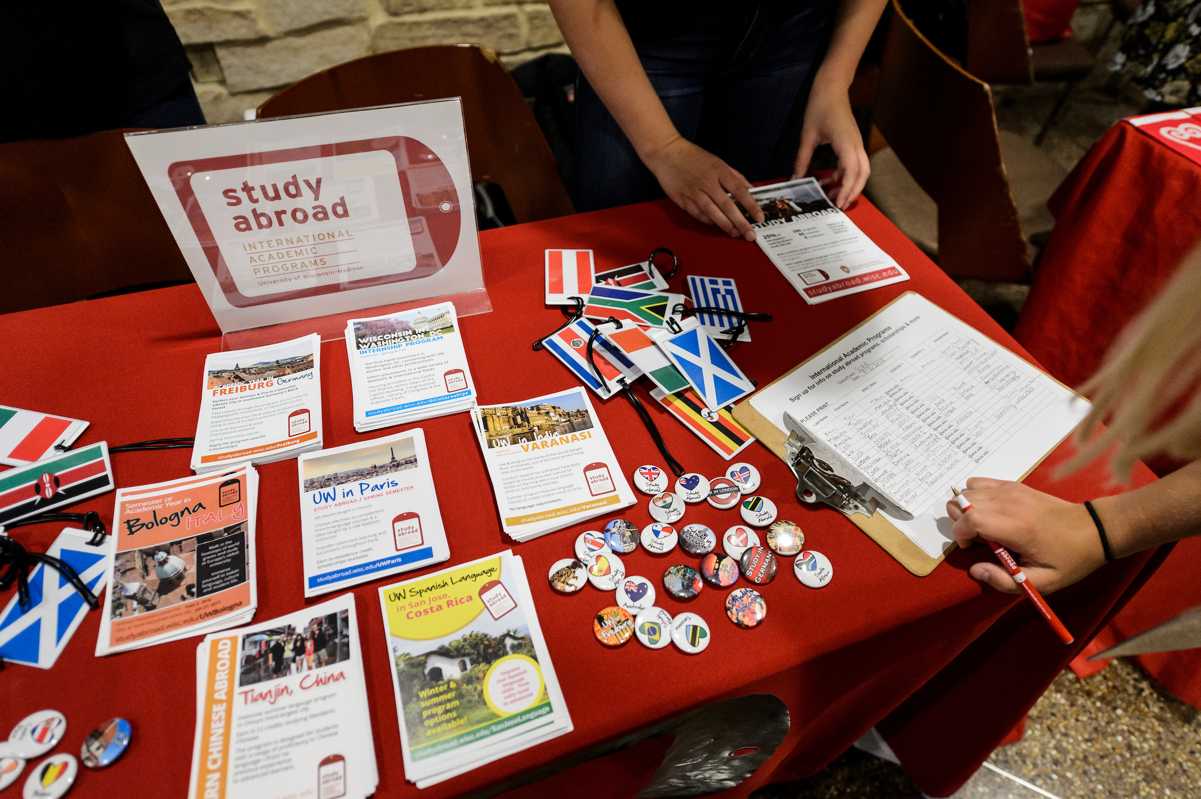 An incoming first-year undergraduate browses information tables and talks with a campus representatives about study abroad programming during a Student Orientation, Advising and Registration (SOAR) campus resource fair at Union South at the University of Wisconsin-Madison on Aug. 9, 2017. Sponsored by the Center for the First-Year Experience, the two-day SOAR sessions provide new students and their parents and guests an opportunity to meet with staff and advisors, register for classes, stay in a residence hall, take a campus tour and learn about campus resources. (Photo by Jeff Miller / UW-Madison)